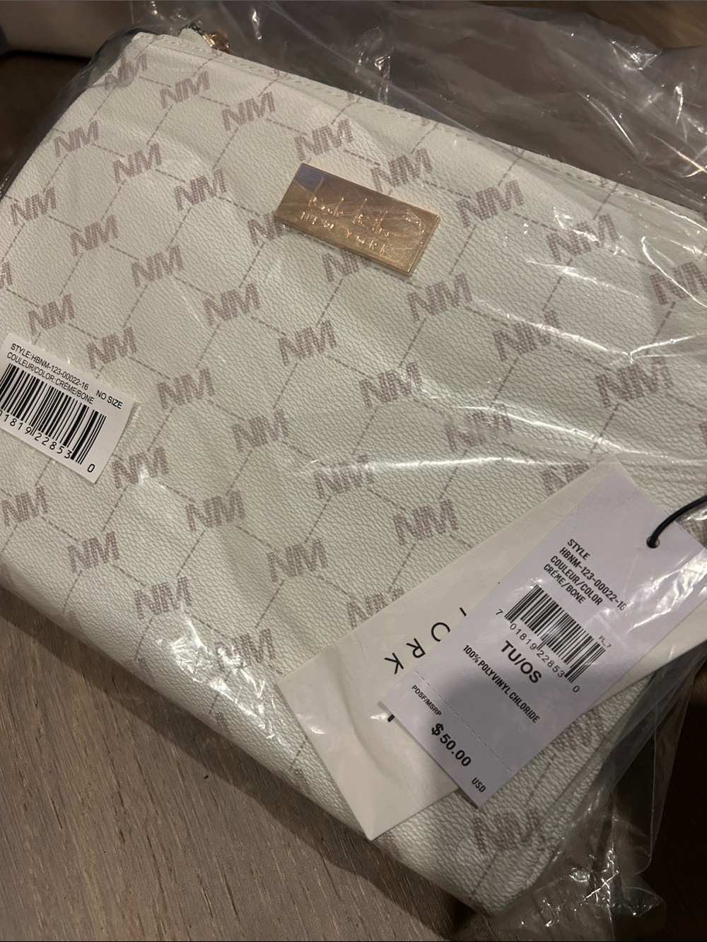 Nicole Miller crossbody bag in a cream/bone color
